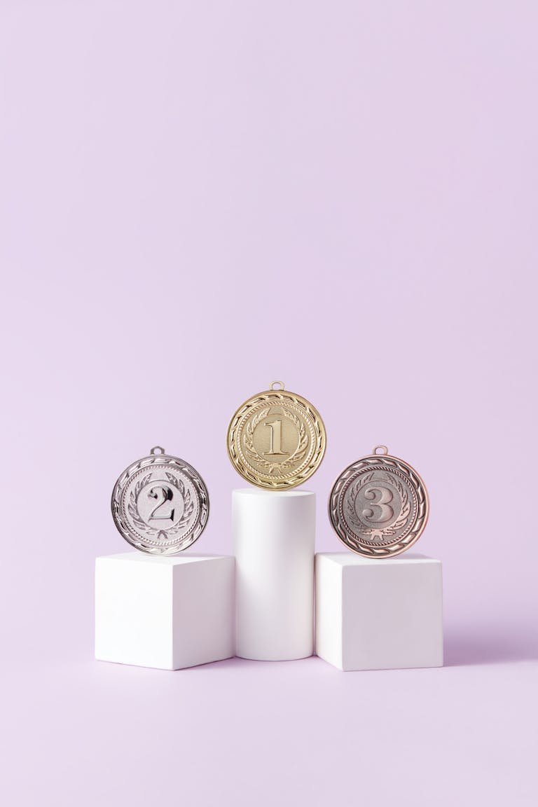Three medals displayed on podium blocks, symbolizing first, second, and third place winners.